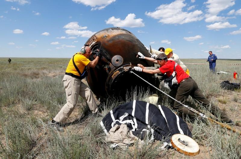 Search and rescue team members roll the Soyuz TMA-19M spacecraft capsule carrying International Space Station (ISS) crew members, Timothy Peake of Britain, Yuri Malenchenko of Russia and Timothy Kopra of the U.S., shortly after landing near the town of Dzhezkazgan (Zhezkazgan), Kazakhstan, June 18, 2016.