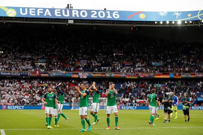 Northern Ireland players applaud fans after the game
