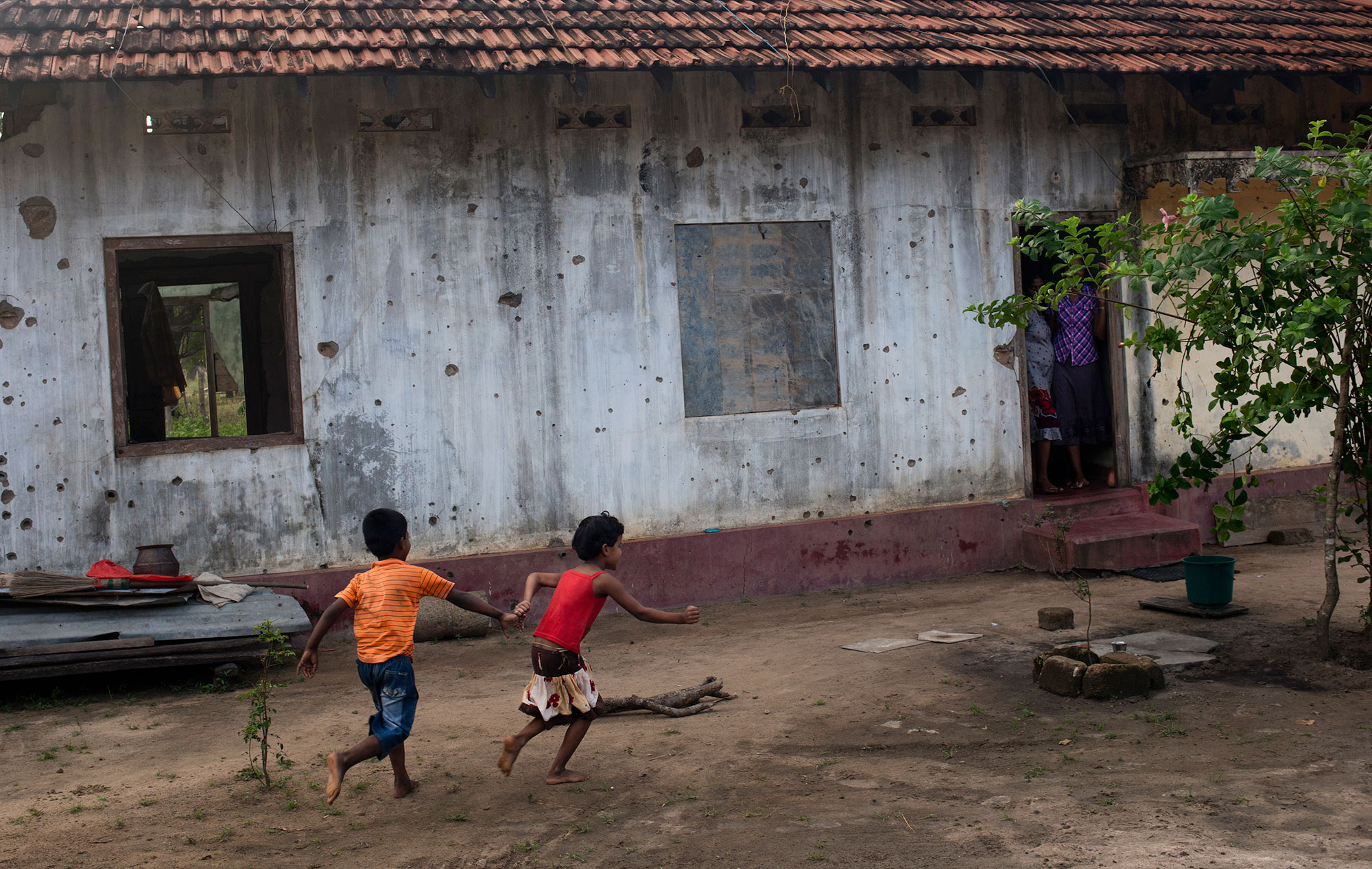 Children play outside their bullet-riddled home in Mullivaikal, which is where the final battle of Sri Lanka's civil war took place. 