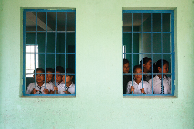 TALKING PERIODS: Students from grades seven to ten look out of a window in Champidevi Higher Secondary School, Lalitpur .