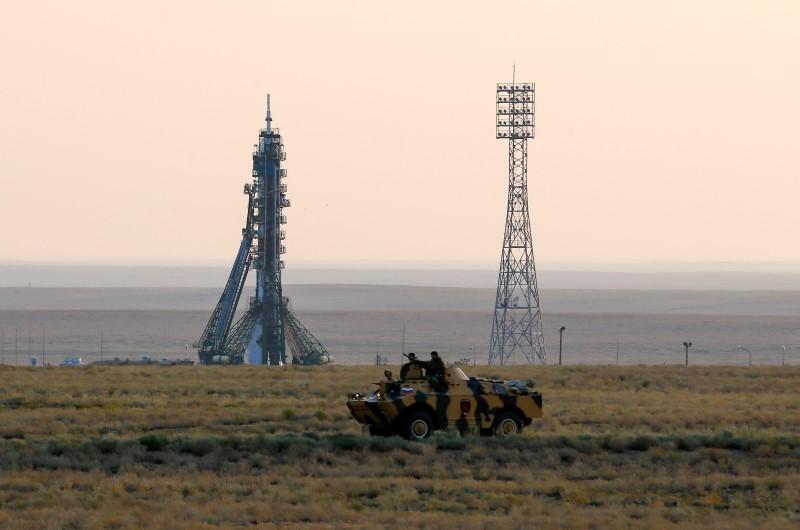 Policemen ride an armoured vehicle in front of the Soyuz MS spacecraft shortly before its launch with the International Space Station (ISS) crew of Kate Rubins of the U.S., Anatoly Ivanishin of Russia and Takuya Onishi of Japan at the Baikonur cosmodrome, Kazakhstan, July 7, 2016. REUTERS/Shamil Zhumatov