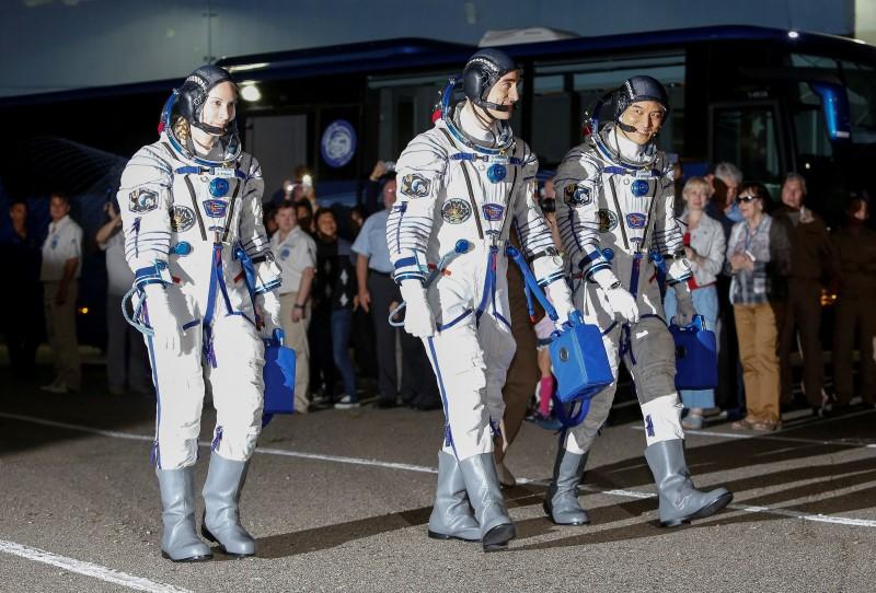 The International Space Station (ISS) crew members (L to R) Kate Rubins of the U.S., Anatoly Ivanishin of Russia and Takuya Onishi of Japan walk after donning space suits at the Baikonur cosmodrome, Kazakhstan, July 7, 2016. REUTERS/Shamil Zhumatov