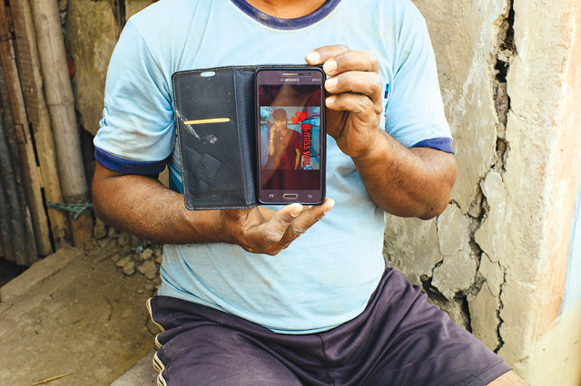BUILDING LIVES: Ram's son Raghu, a migrant worker in Doha, lives in a camp with 9,200 others and shares his room with seven Nepali workers. His family has built a house with the money he sent back home.