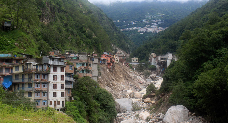 Houses along the Bhotekoshi River in Liping, Sindhupalchowk, poised precariously at the edge of landslides triggered by recent flooding pictured on Sunday. The landslide site is located near the Nepal-China border. 