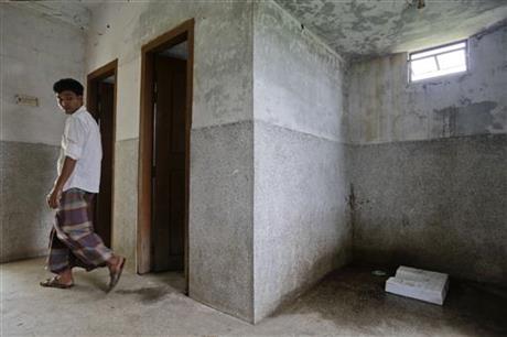 In this May 30, 2016 photo, a Bangladeshi man walks inside a public toilet in Bormi village, near Dhaka, Bangladesh. Through a dogged campaign to build toilets and educate Bangladeshis about the dangers of open defecation, the densely populated South Asian nation has managed to reduce the number of people who defecate in the open to just 1 percent of the 166 million population, according to the government, down from 43 percent in 2003.