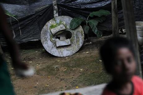 In this May 30, 2016 photo, a broken toilet seat stands in the backyard of a house in Bormi village, near Dhaka, Bangladesh. Through a dogged campaign to build toilets and educate Bangladeshis about the dangers of open defecation, the densely populated South Asian nation has managed to reduce the number of people who defecate in the open to just 1 percent of the 166 million population, according to the government, down from 43 percent in 2003.