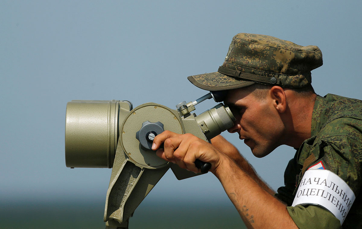 A Russian servicemen uses binoculars during a competition of the International Army Games 2016 at a range in the settlement of Alabino outside of Moscow. 