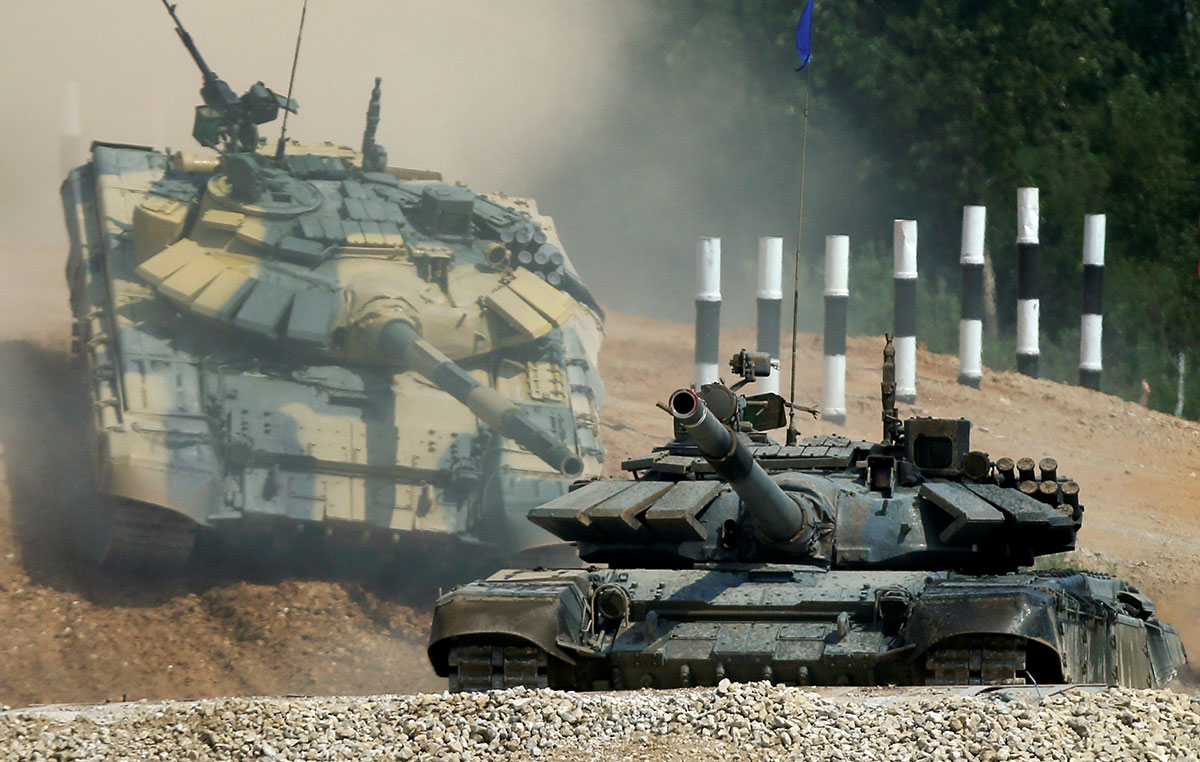 T-72 tanks, operated by crews from Kuwait (front) and Nicaragua, drive during the Tank Biathlon competition, at a range in the village of Alabino outside Moscow. 