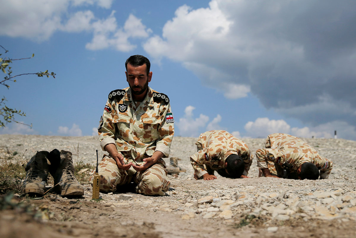 Iranian servicemen pray during the Paratrooper's platoon competition for airborne squads, part of the International Army Games 2016, at the Rayevsky shooting range outside the Black Sea port of Novorossiysk. 