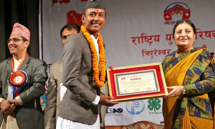 President Bidya Devi Bhandari honours star footballer, Nawyug Shrestha, amid a programme organised by the National Youth Council on the occasion on International Youth Day, in Kathmandu, on Friday, August 12, 2016. Photo: RSS