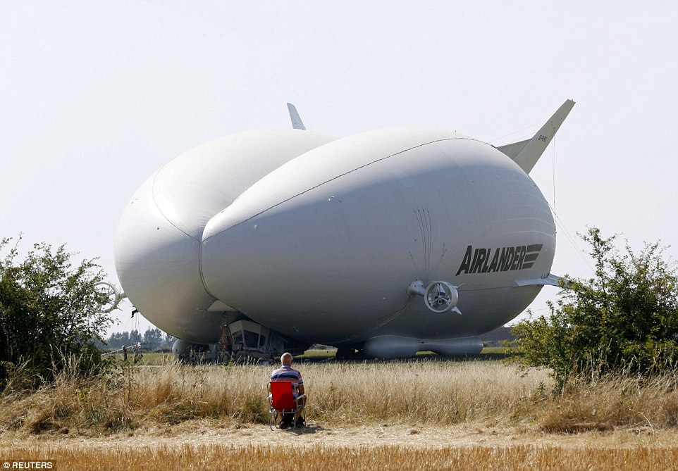 One lone man sets up a deckchair earlier in the day to secure a good spot for the maiden voyage of the Airlander (pictured)