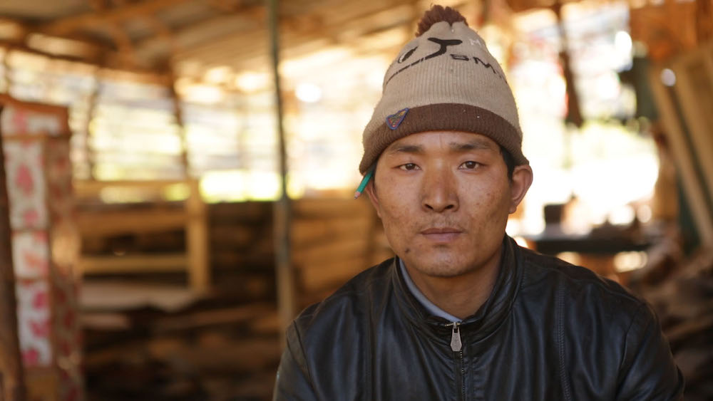 Jangbu Sherpa works at a sawmill in Libang. He had left school to join the Maoists [Prabhat Jha/Al Jazeera]