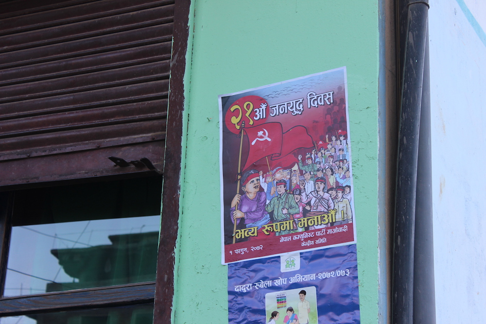 A poster by a breakaway Maoist group calls on people in Libang to mark the war anniversary [Prabhat Jha/Al Jazeera]