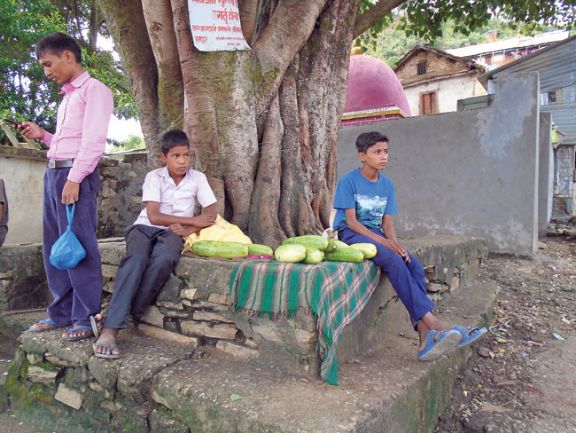 Two boys sell cucumbers near the Krishna Mandir in Mangalsen, Achham. (Damara)