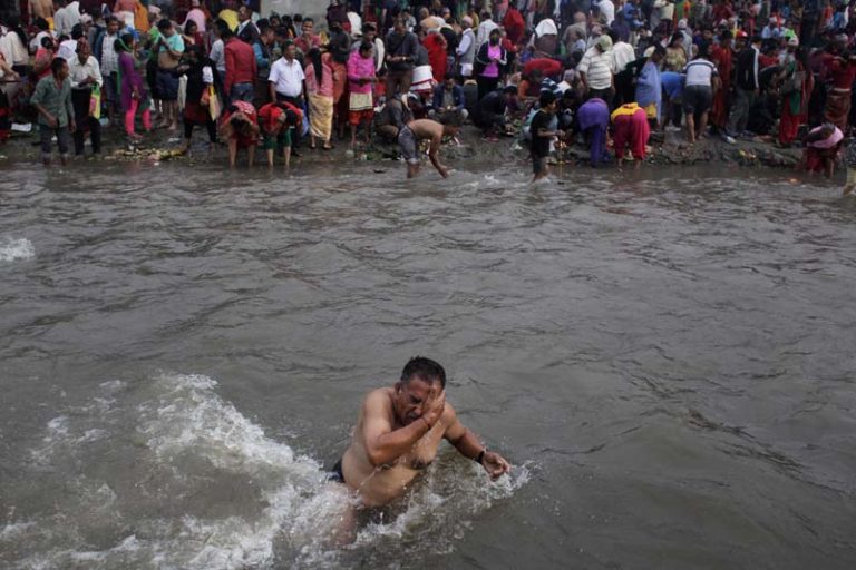 A Nepalese devotee takes a holy dip in Bagmati river during Kuse Aunsi in Gokarneshwar Hindu temple, Kathmandu, Nepal, Thursday, Sept. 1, 2016. Kuse Aunsi is a Hindu festival of Nepal where fathers, living or dead, are honored. Children with living fathers show their appreciation by giving presents and sweets and those whose fathers are deceased pay tributes at Gokarneshwar temple. (AP Photo/Niranjan Shrestha)