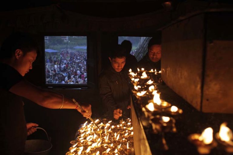 Nepalese devotees light butter lamps in honor of their deceased father during Kuse Aunsi in Gokarneshwar Hindu temple, Kathmandu, Nepal, Thursday, Sept. 1, 2016. Kuse Aunsi is a unique Hindu festival of Nepal where fathers, living or dead, are honored. Children with living fathers show their appreciation by giving presents and sweets and those whose fathers are deceased pay tributes at Gokarneshwar temple. (AP Photo/Niranjan Shrestha)