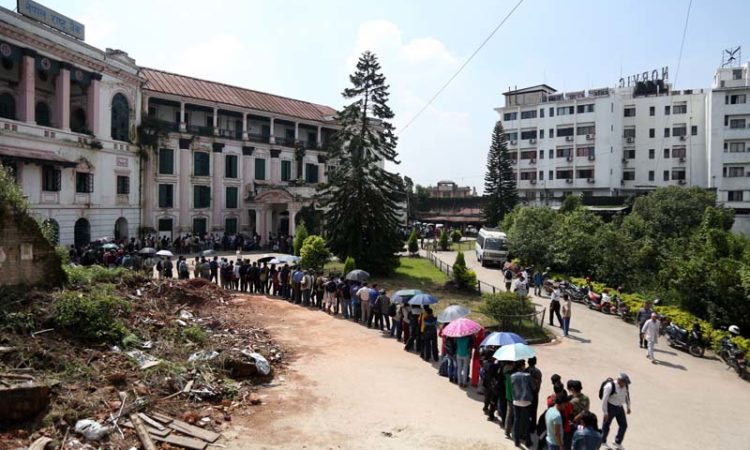 People are seen standing in a queue outside the Nepal Rastriya Bank to exchange old notes with new ones for Dashain festival, in Thapathali of Kathmandu, on Sunday, October 2, 2016. Photo: RSS