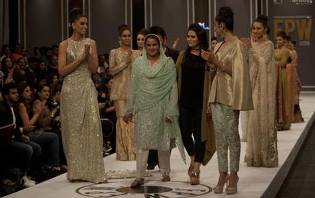 Pakistan's gang rape victim Mukhtar Mai, centre, walks with models during a fashion show in Karachi, Pakistan, Tuesday, Nov. 1, 2016. Gang-raped and paraded naked 14 years ago, Mukhtar Mai walked on a ramp in Pakistan fashion week on Tuesday. A red-carpet reception accorded in Pakistani southern city of Karachi by country's elite fashionista is her debut appearance, which she says she's doing as a symbol of courage for womenfolk.