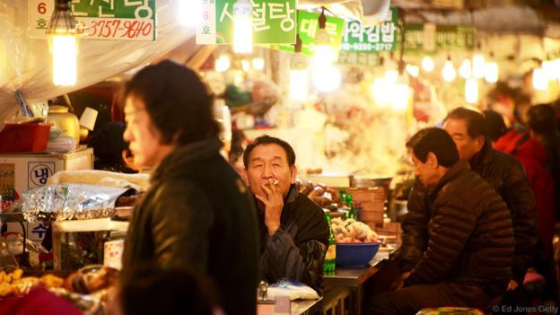 Enjoying one of the many quirky eateries in Seoul (Credit: Ed Jones/Getty)