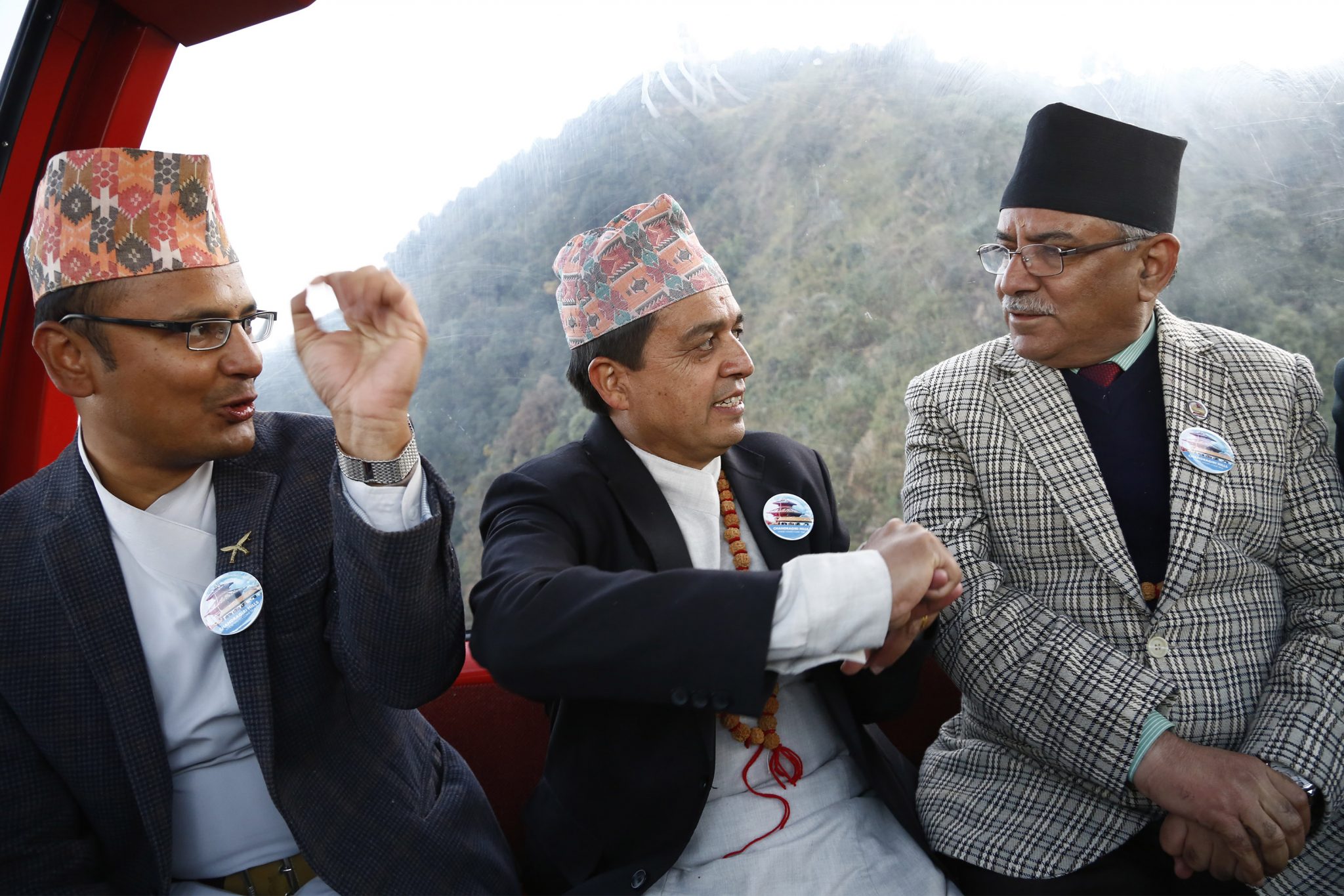 Prime Minister Puspa Kamal Dahal riding on a cable car during Chandragiri Cabal car officialy launching ceremony at Chandragiri Hill, Kathmandu on Thursday.Also seen in Photo Chandra Dhakal, Chairman of Chandragiri Cable Car.  POST PHOTO/PRAKASH CHANDRA TIMILSENA