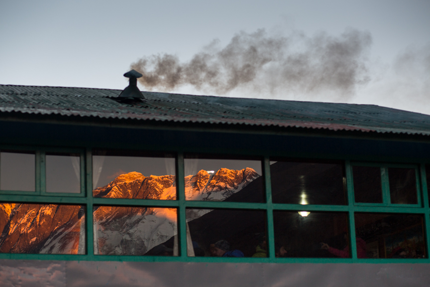 Smoke emitted from a hotel in Debuche as the sun sets over Mount Everest. Recent studies show that black carbon from such smoke is causing faster retreat of the glaciers in Himalaya region.