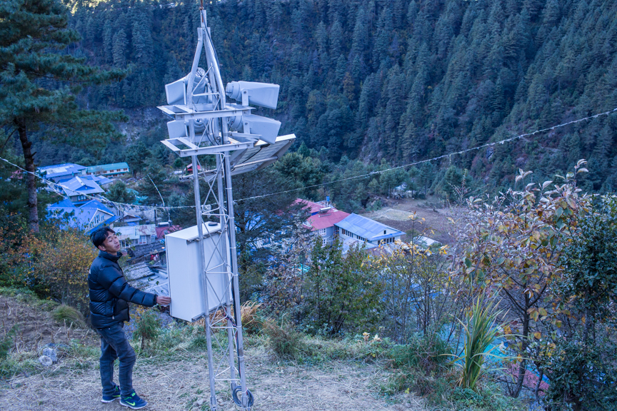 Nang Thume Sherpa, member of glacier lake task force, shows the early warning system installed in Fakding village, Solukhumbu. The early warning system will send automated messages from from a sensor installed in Imja lake.