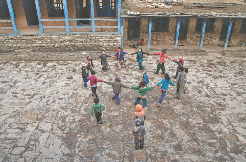 Children playing the classic â€˜Euta Sathi Jungle Maâ€™ during recess.